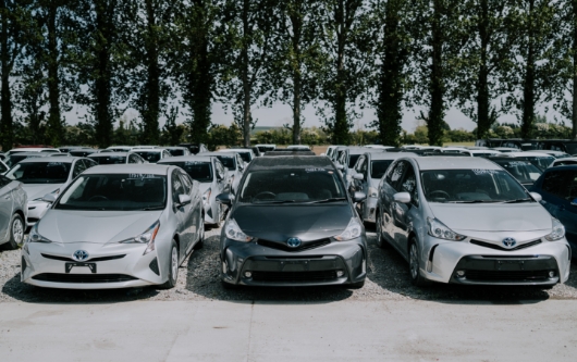 image showing a line of cars for sale